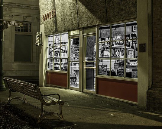 Joe's Barber Shop

This is an image of Joe's Barber shop located in downtown Vacaville, Ca. 
I was looking for a nostalgic look as walked through town that night. I think this fit well and I added some selective coloring to get the mood I was looking for.
The foreground has a city bench facing the front of the barber shop. 
The exterior of the shop looks like it was built in the late 50's or maybe the early 60's. The front is made of a beige colored stucco look with big windows that let us look in to the old style shop. Below the windows are a couple of red panels.
Inside the shop you can see everything you would think you would find in an old shop.