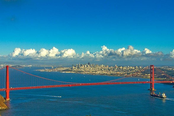 Golden Gate and The City

This is an imaging the bridge and San Francisco.
The foreground is the blue waters of the Pacific Ocean. There is a large tanker ship heading in towards the San Francisco Bay just about to pass under the Golden Gate Bridge.
The Golden Gate Bridge is seen spanning the Golden Gate from the Marin Headlands to San Francisco.
Beyond the bridge is the San Francisco Bay and the city of San Francisco in the center right of the image.
Behind all of this are some large puffy clouds from a clearing storm blowing east.