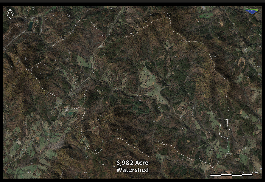 High-resolution satellite photo map of a 6,982 Acre watershed with its upper limits defined by a white dotted line.