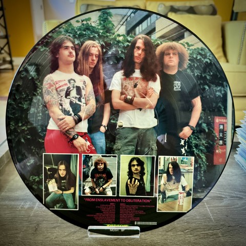 Picture of the band in what looks like an English garden. Bunch a long hair dudes, one wearing a t-shirt with The Texas Chainsaw Massacre on the front. 

Individual pictures of each band member below, in their own rectangular box. 

Track listing and album credits in red text