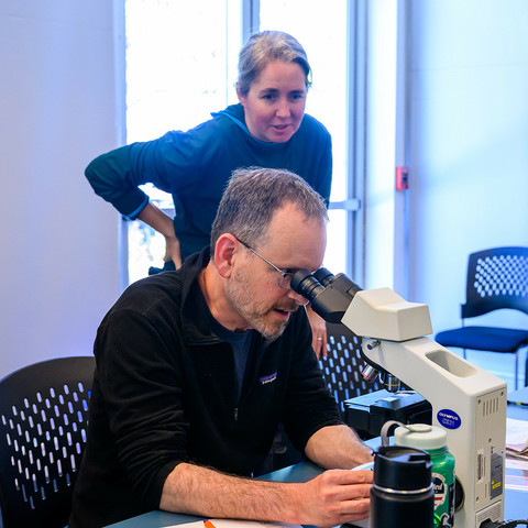 Baykeeper scientist Jon Rosenfield looking through a microscope
