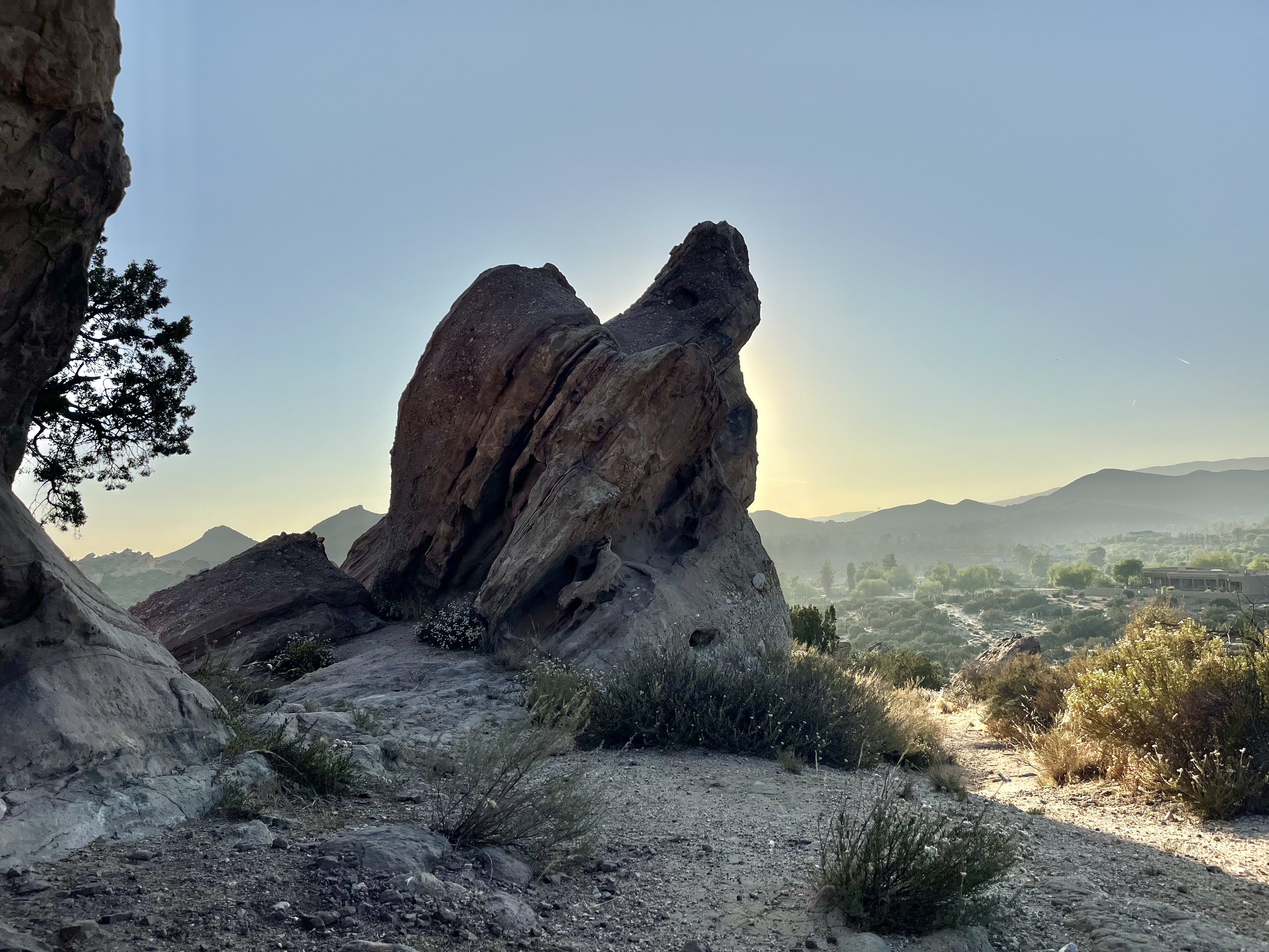 Large rock formation with sun setting behind Large rock formation with sun setting behind