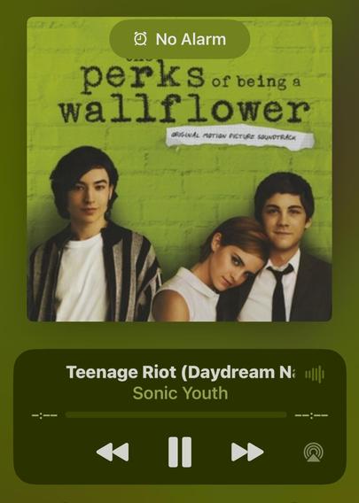 The album cover art from The Perks of Being a Wallflower (Original Motion Picture Soundtrack). It features a lime-green brick wall background with three characters leaning together, a well-known promotional image for the film.

Currently Playing Song:
The track displayed is “Teenage Riot (Daydream Nation)” by Sonic Youth.