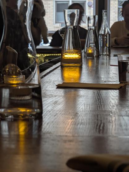 A photo of the LCD candles though water bottles on a bar