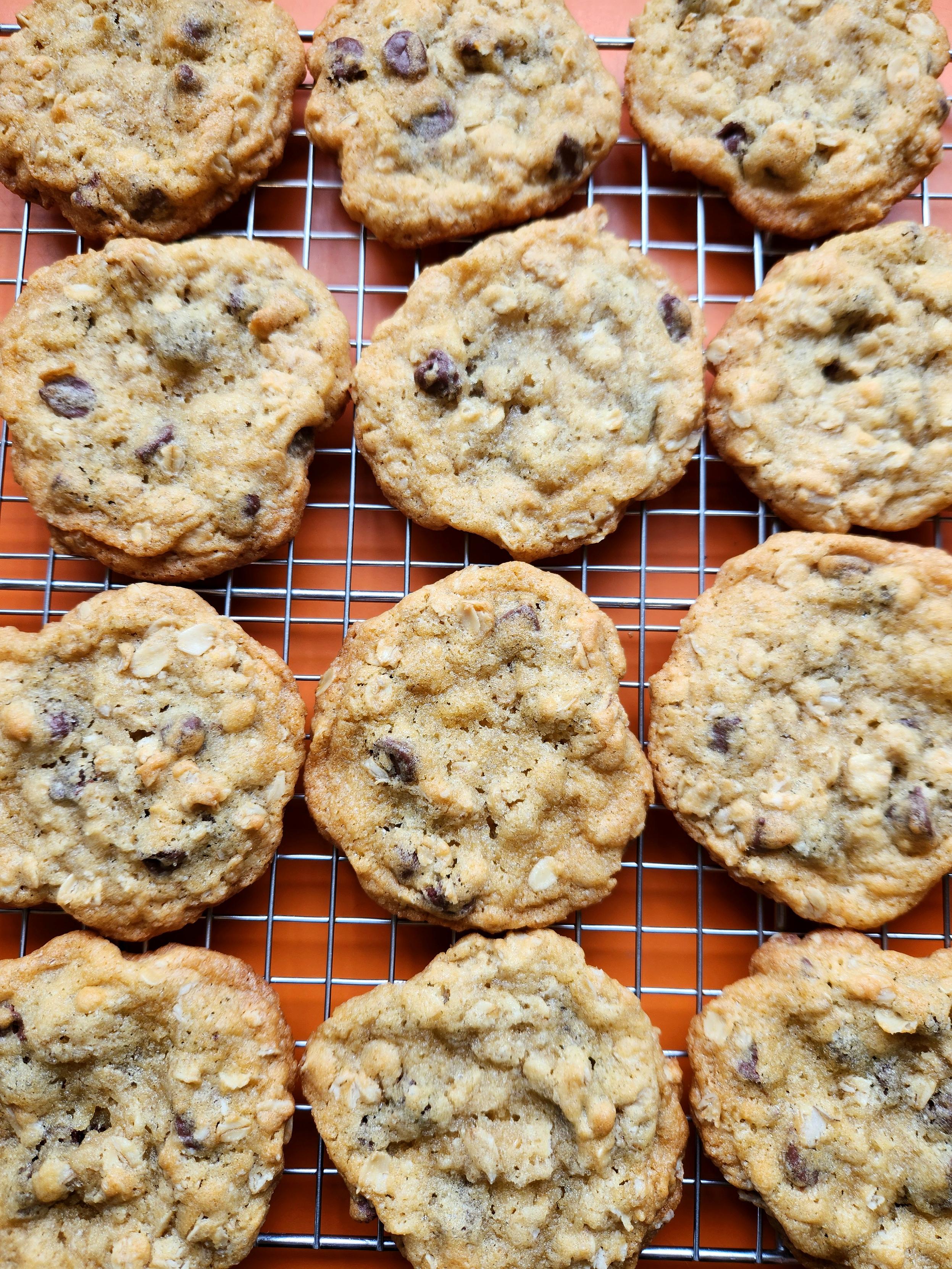 Chocolate chip and oatmeal cookies cooling on a wire rack.