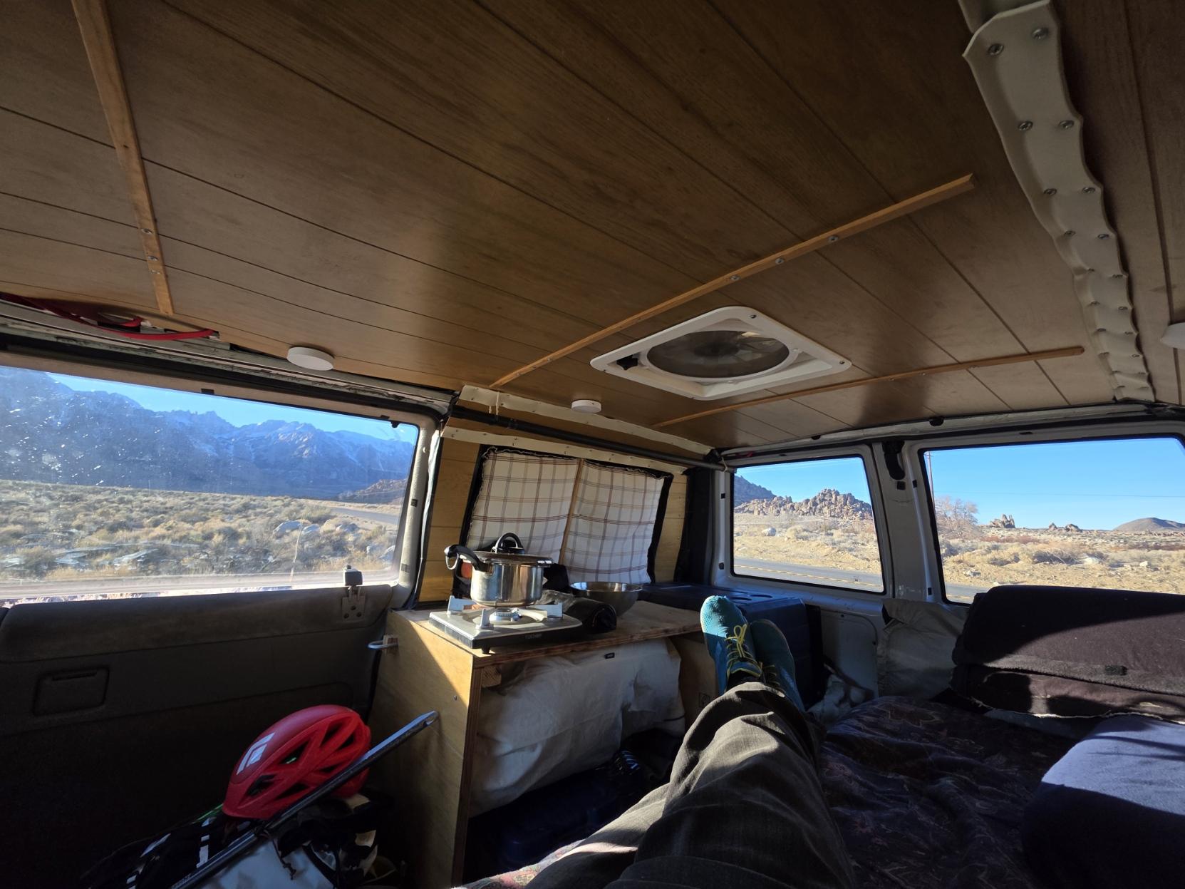 Relaxing in a camper van with alpine views out the windows