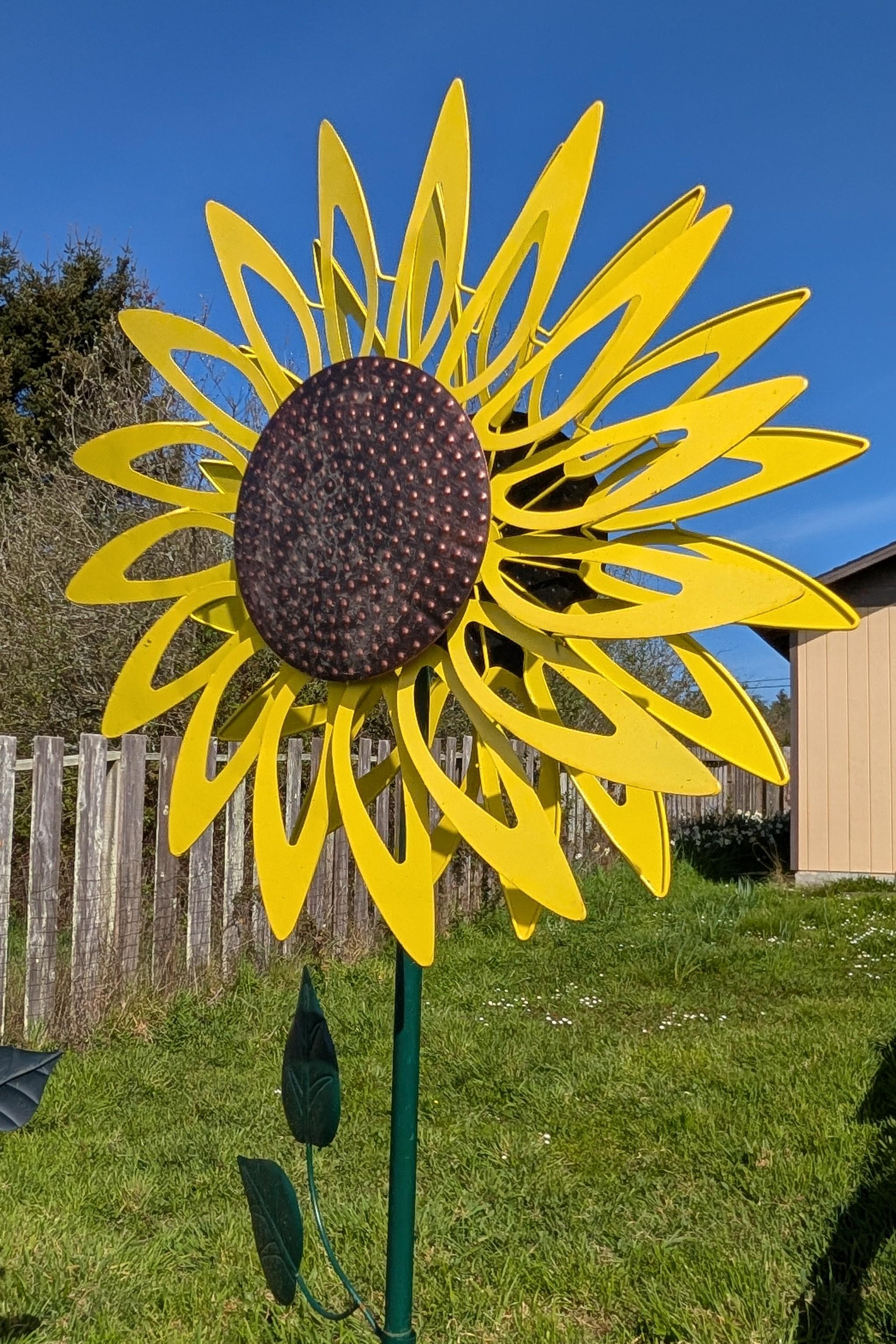 A giant yellow metal sunflower that turns and spins with the wind.